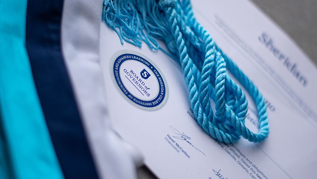 Certificate with sash in Sheridan colours laying on top.