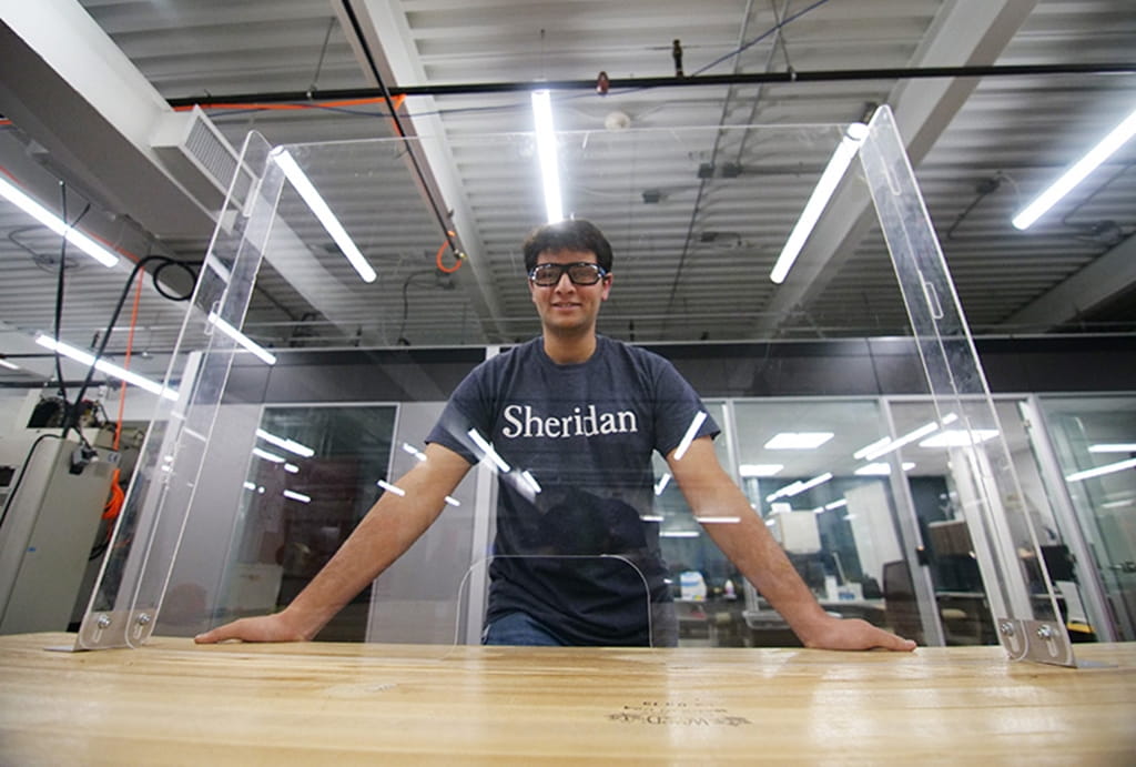Ramzy Ganady with one of the protective countertop shields made at Sheridan