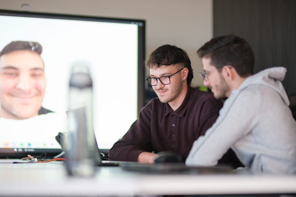 Two researchers sit at a table in Sheridan's Centre for Applied AI