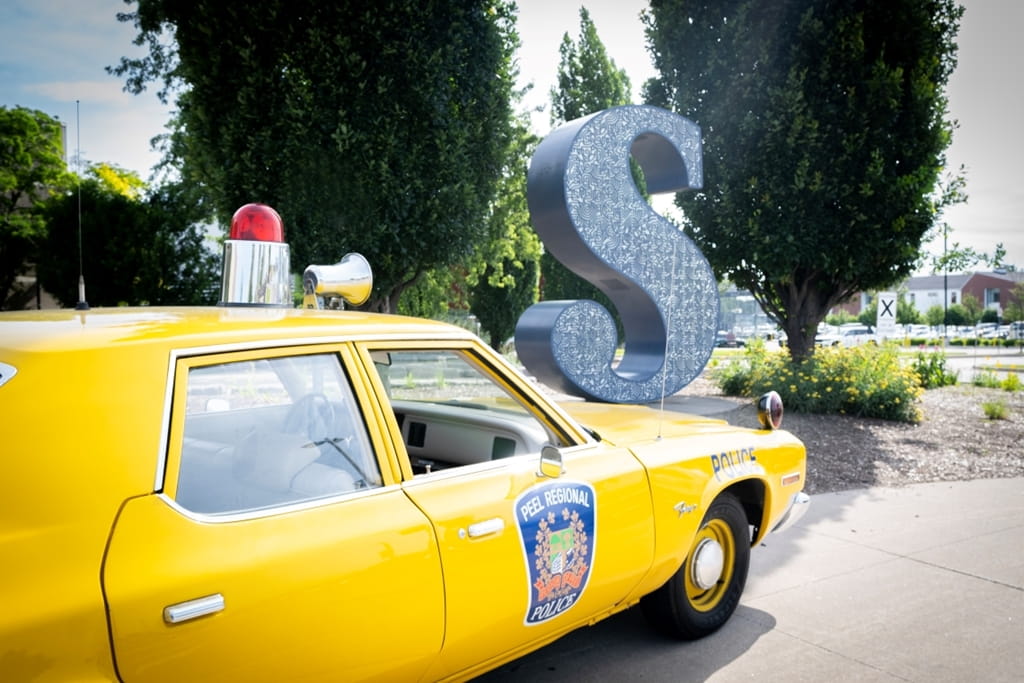 Yellow Peel Regional Police car with siren in front of Sheridan S