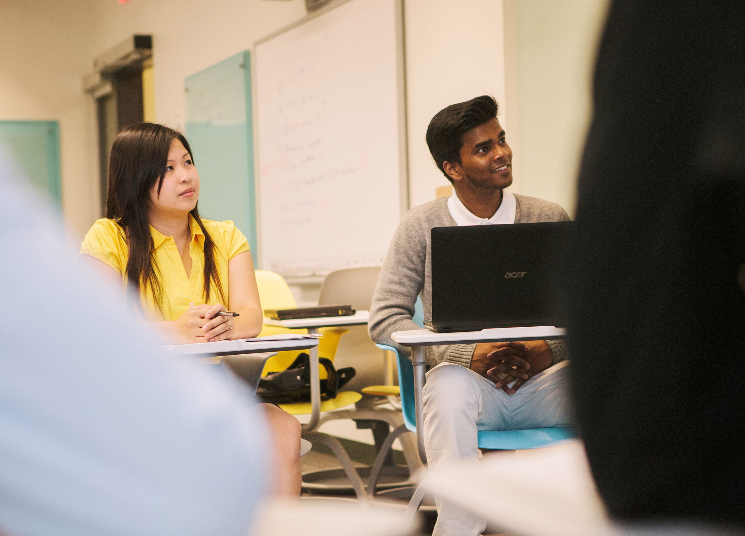 Finance student writing notes in a notebook