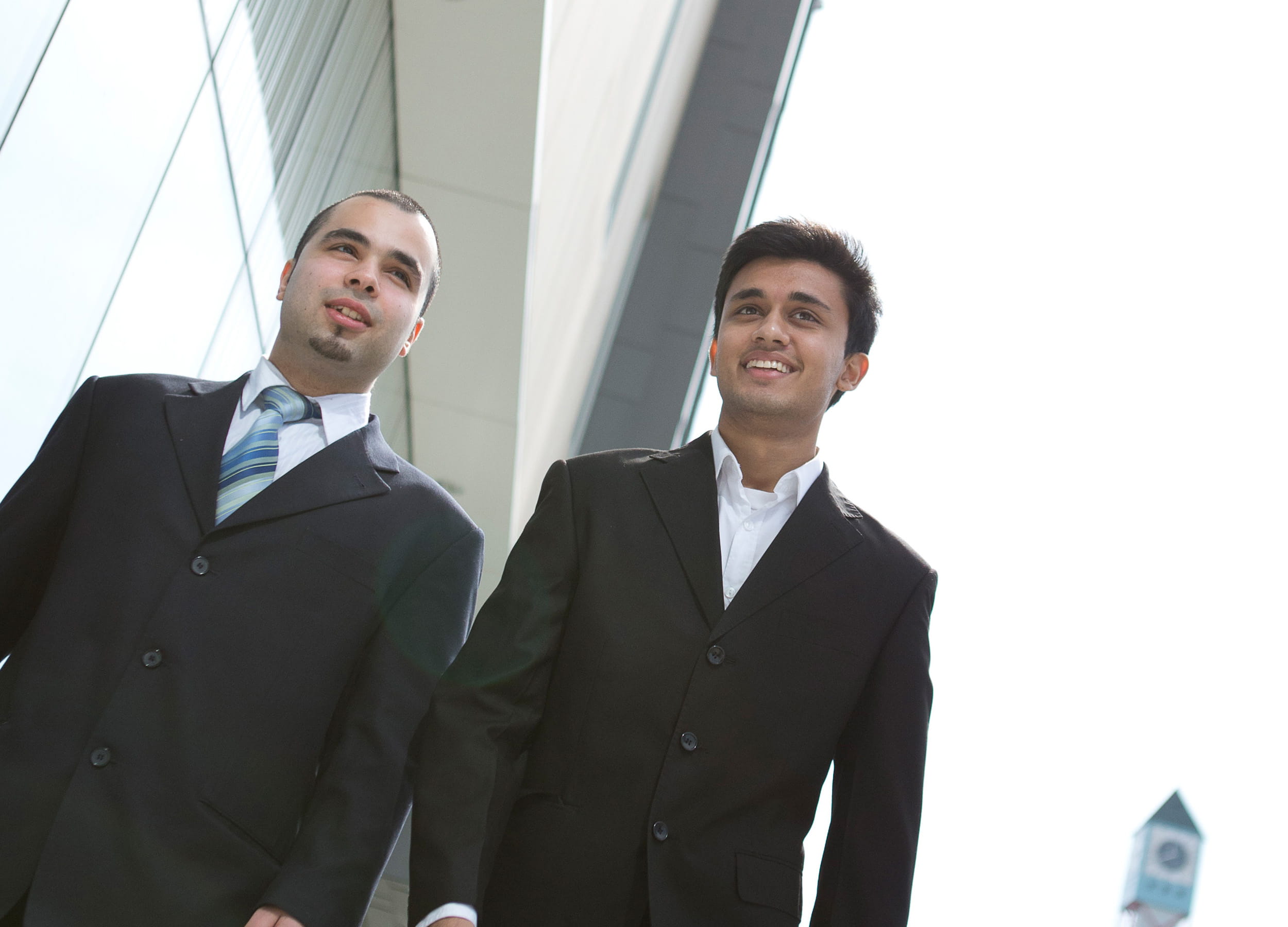 Two men wearing suits