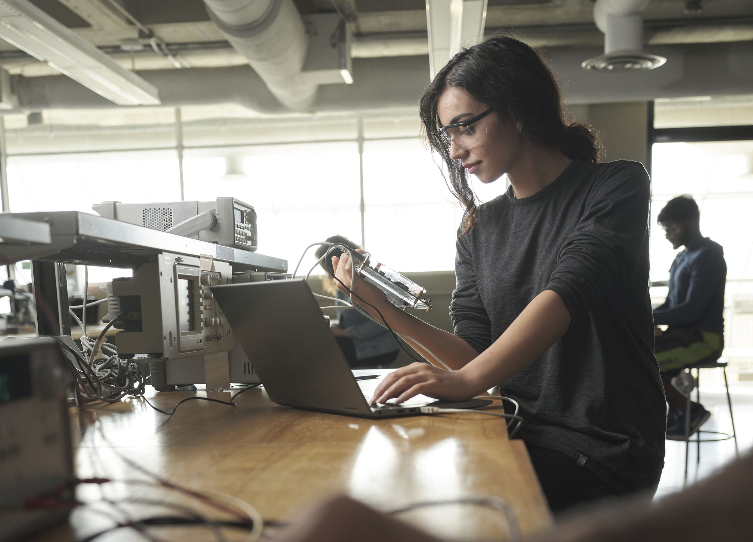 A student working with equipment in a computer engineering lab at Sheridan