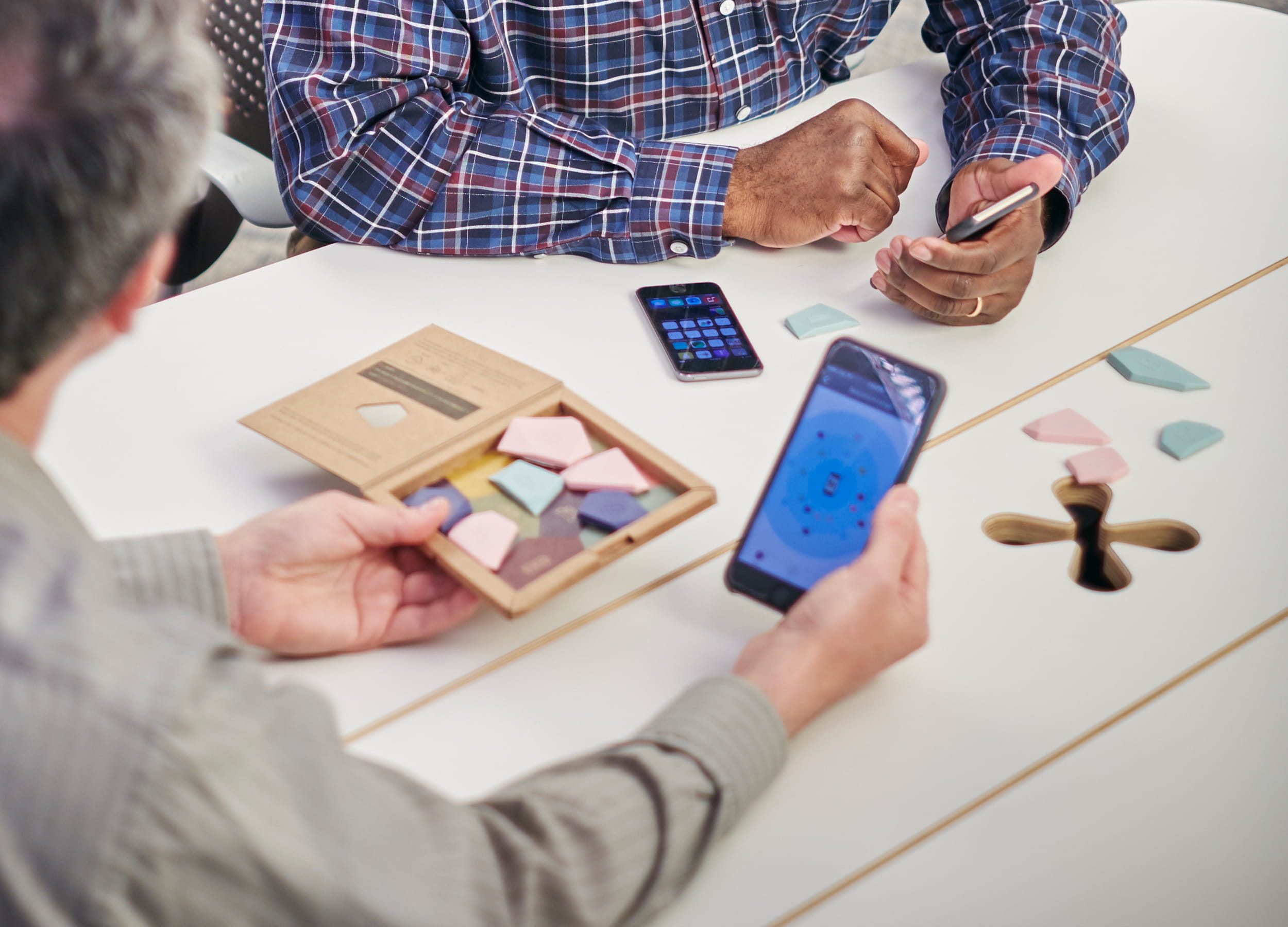 Student and teacher looking at smart phones in a classroom