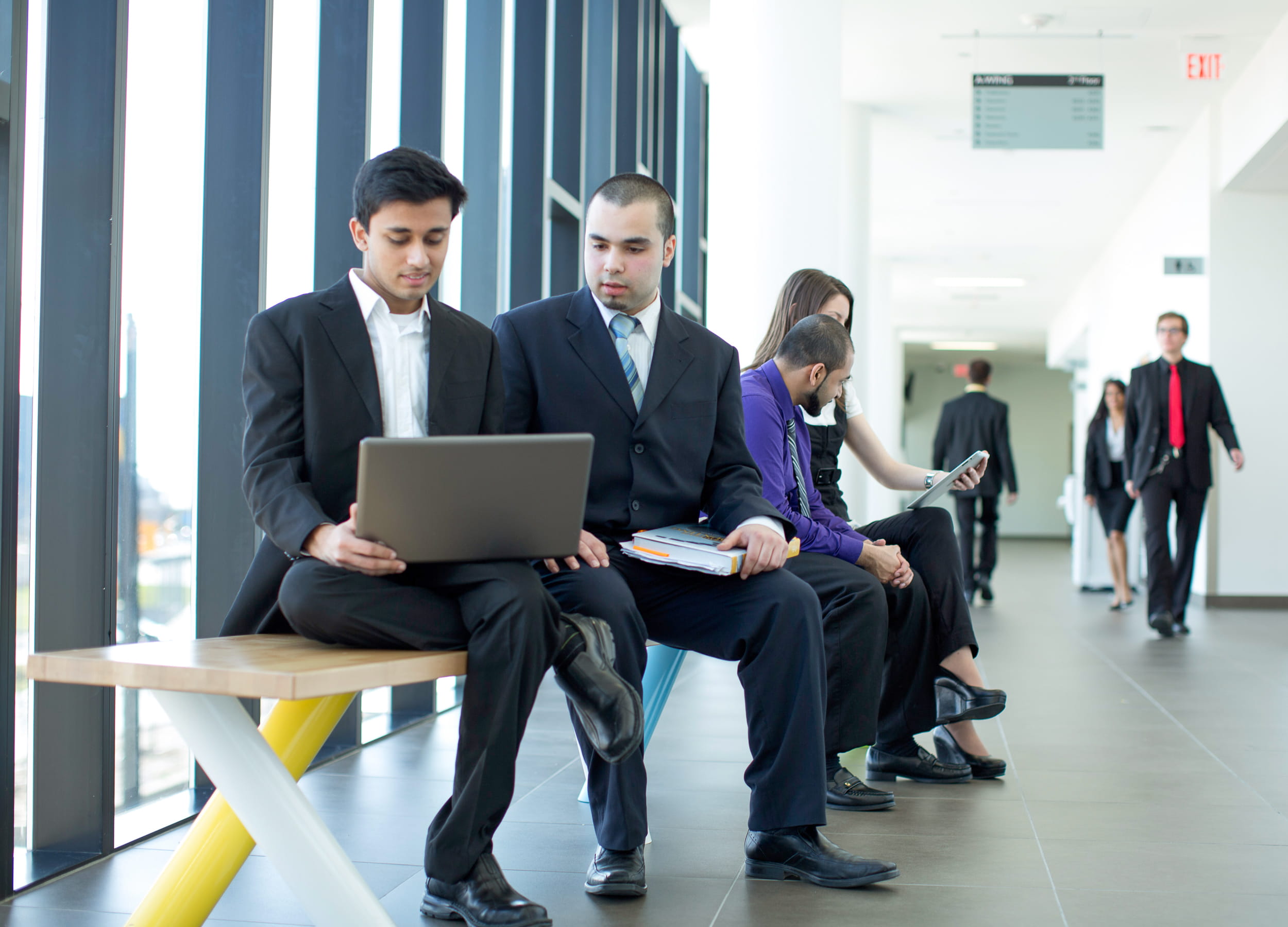 Paralegal students looking at a laptop