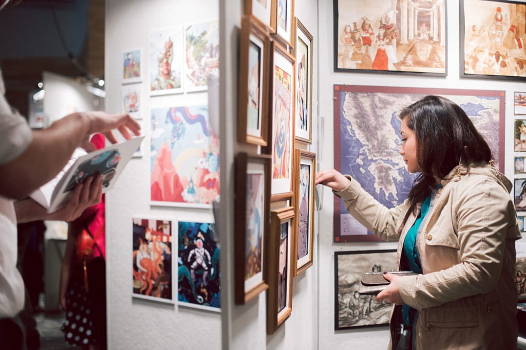 A woman looking at art on the wall in a gallery
