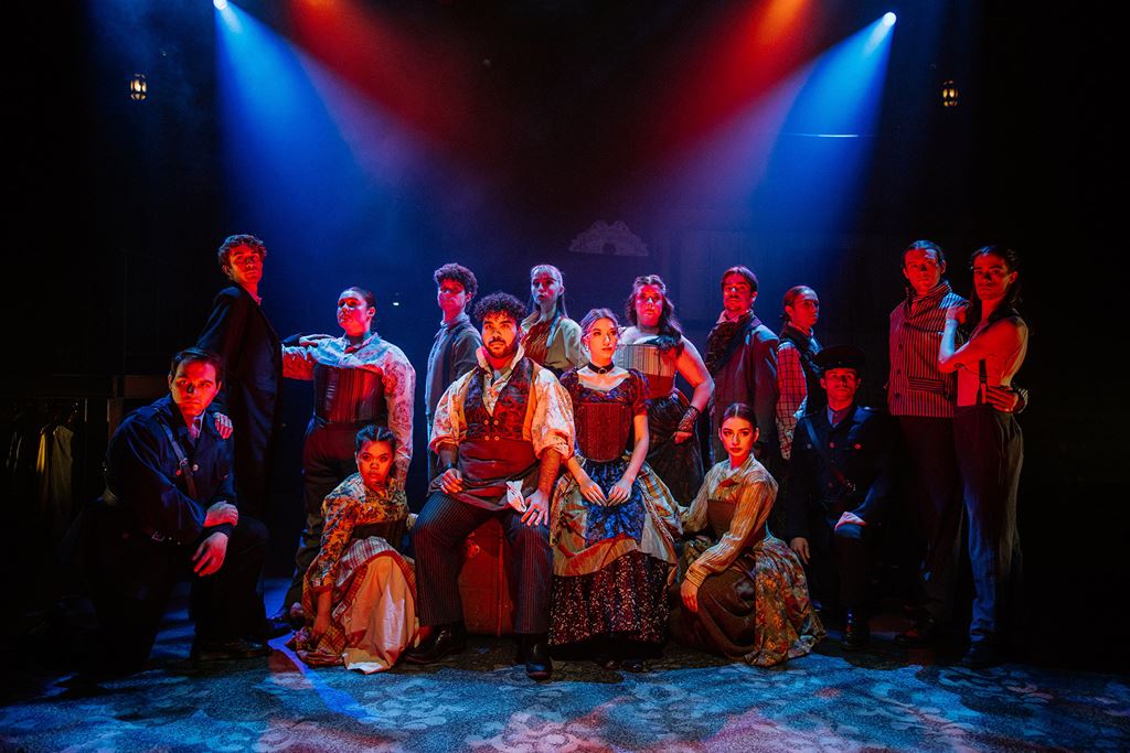 Group of students in costume performing on stage