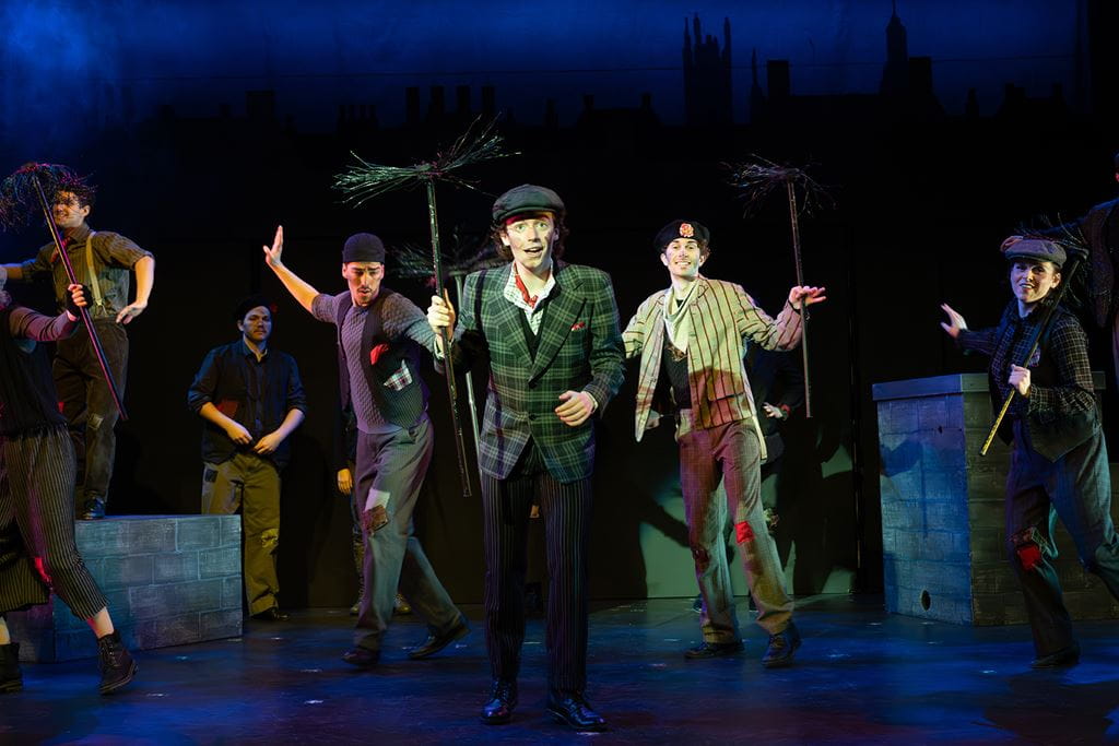 Group of students in costume dancing on stage